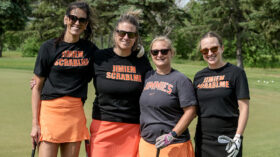 Four women pose for a portrait at the Jimmie Scramble golf tournament.
