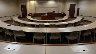 classroom with seats surrounding a center lectern